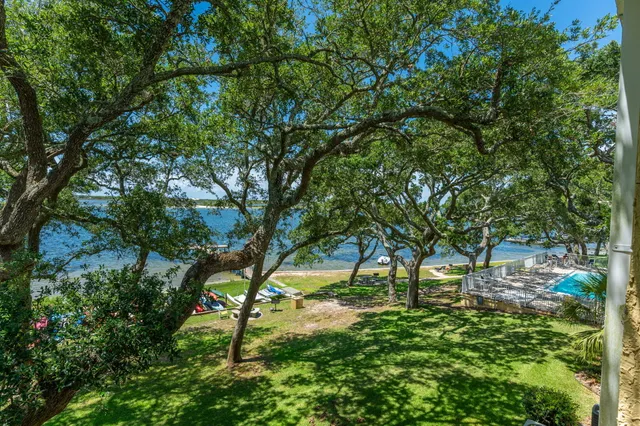 a aerial view of a house with a yard and lake view