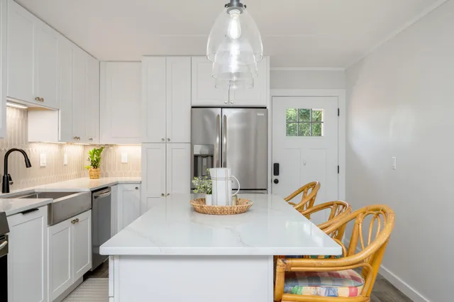 a kitchen with stainless steel appliances a refrigerator stove and sink