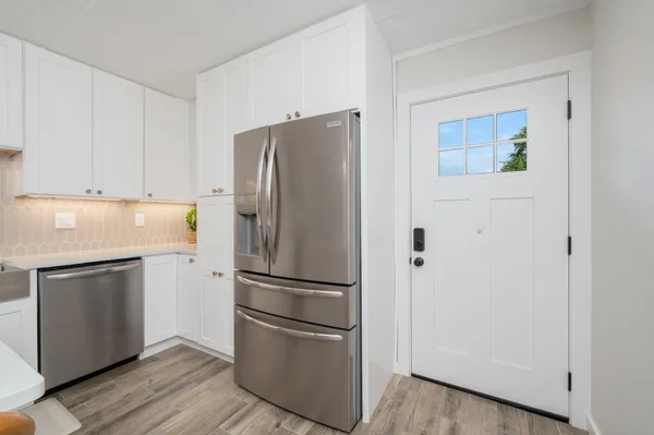 a kitchen with appliances a sink and cabinets