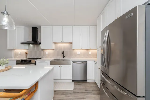 a kitchen with a stove a sink and a refrigerator