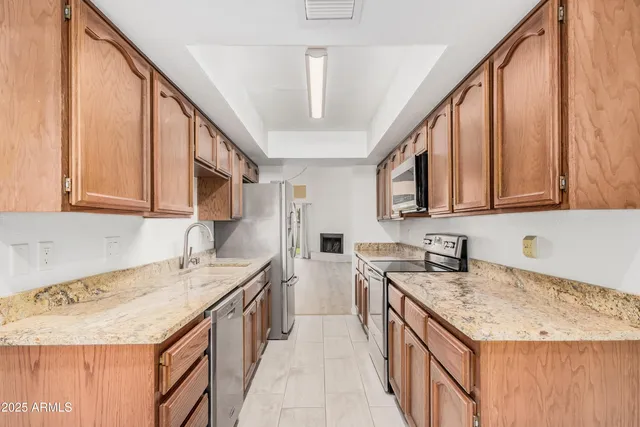 a kitchen with a sink stove and cabinets
