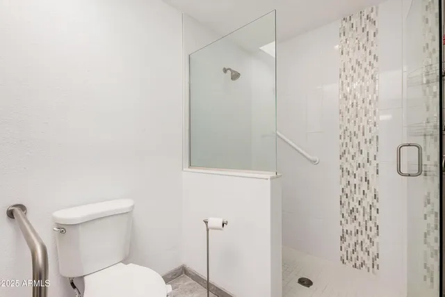 a white toilet sitting next to a bathroom sink