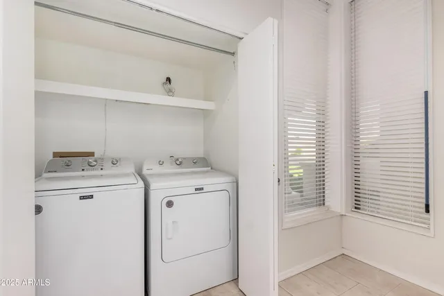 a view of storage and utility room with washer and dryer