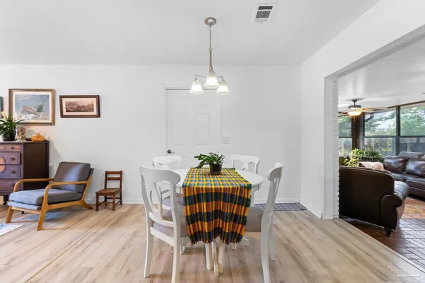 a dining room with furniture and wooden floor