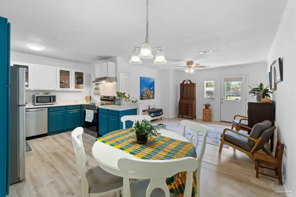 a view of a dining room with furniture and wooden floor
