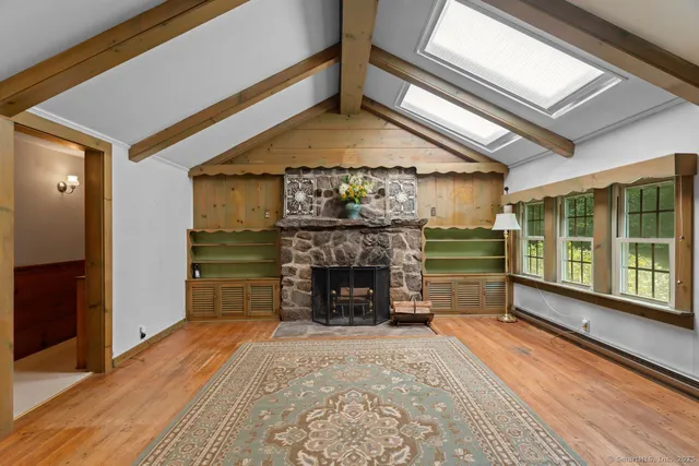 a view of an empty room with a fireplace and a window