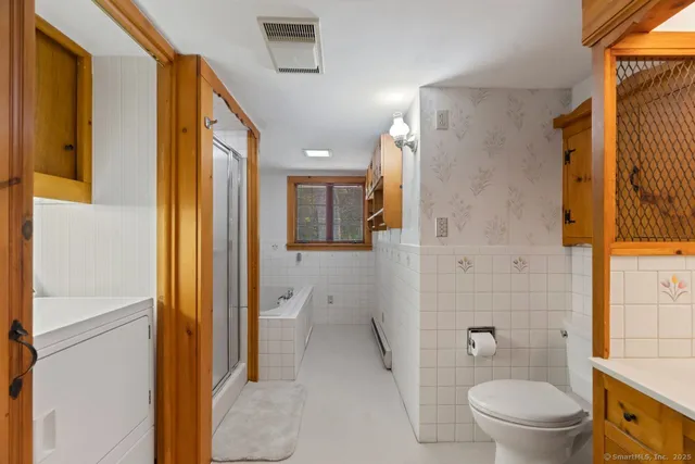 a bathroom with a granite countertop toilet sink and shower
