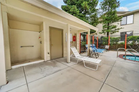 a view of a patio with table and chairs and potted plants