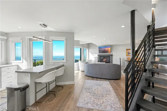 a living room with furniture and a floor to ceiling window