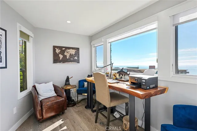 a view of a kitchen with refrigerator and windows