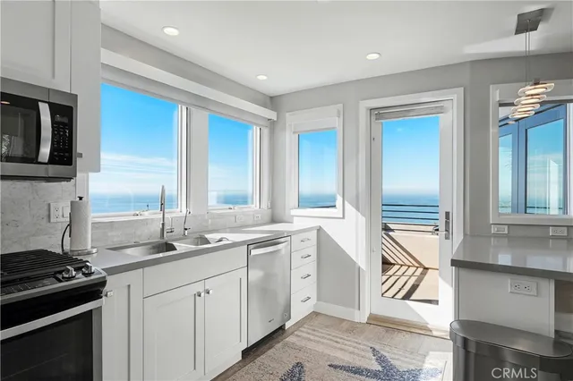 a kitchen with sink cabinets and dining table