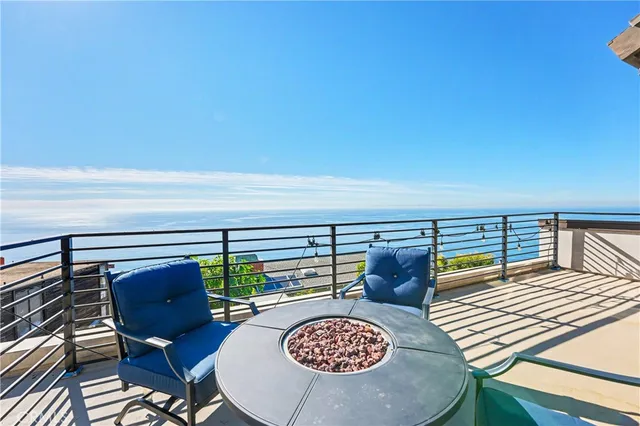 a view of a balcony with chairs and wooden floor