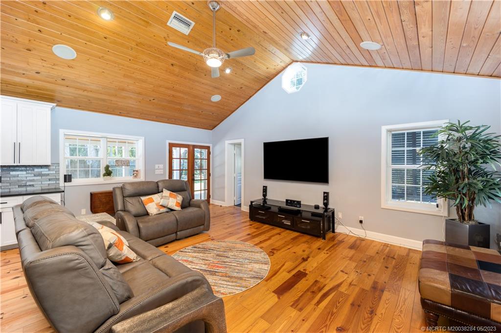 109 South Sewalls Point Road Stuart, FL 34996 - Photo 5 of 45 a living room with furniture and a flat screen tv