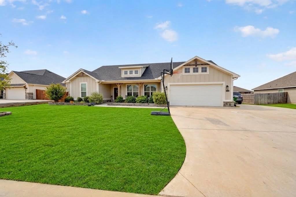 113 Ridgetop Trail Rhome, TX 76078 - Photo 2 of 32 Craftsman-style exterior with board and batten siding, stone accents, and a covered entry