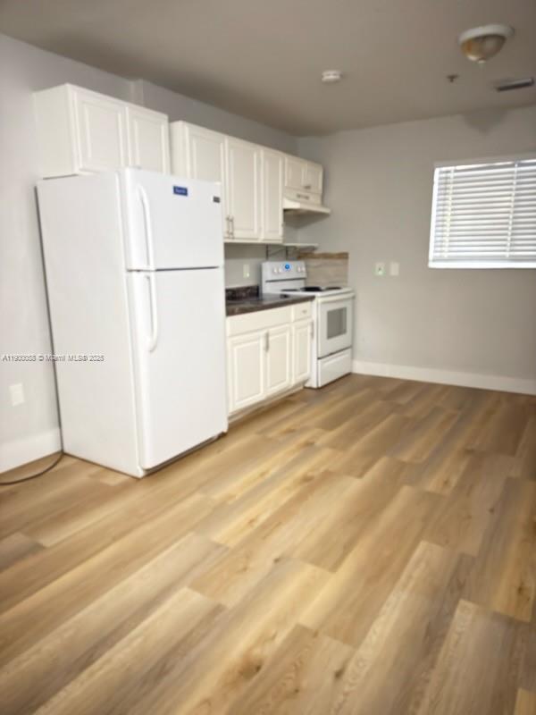 a white refrigerator freezer sitting in a kitchen