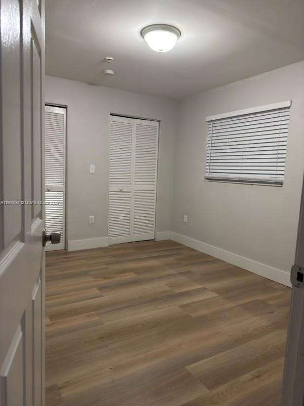 1930 Southwest 2nd Street, Unit 1 Miami, FL 33135 - Photo 3 of 3 an empty room with wooden floor and windows