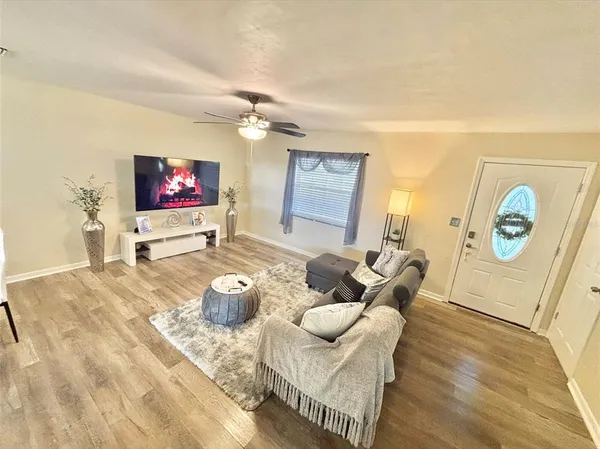 a living room with furniture and a flat screen tv