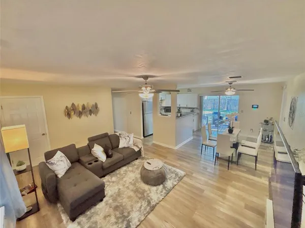 a living room with furniture and a wooden floor