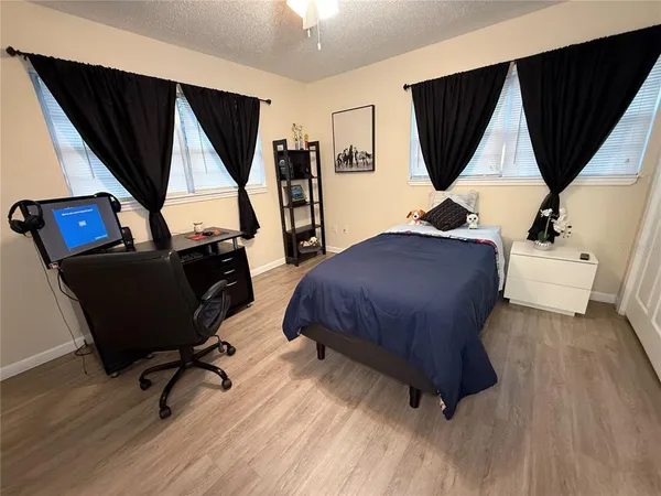 a bedroom with furniture and a window