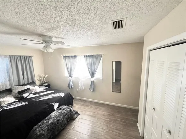 a bedroom with a bed and a chandelier