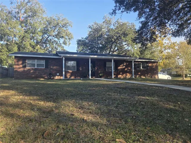 a front view of house with yard space and outdoor seating