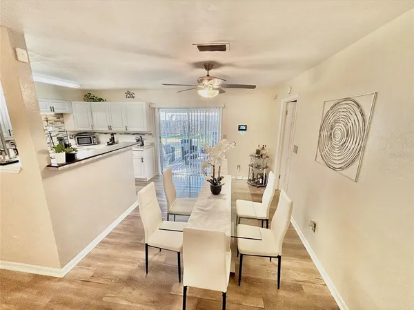 a dining room with kitchen island a stove and a refrigerator
