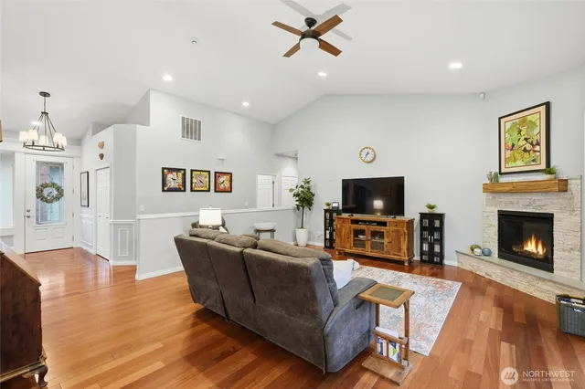 a living room with furniture a flat screen tv and a fireplace