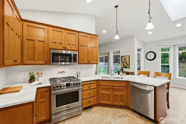 a kitchen with a sink stove and microwave