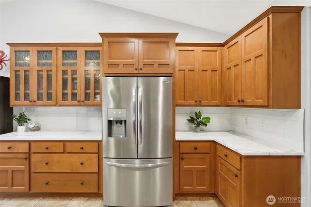 a kitchen with stainless steel appliances granite countertop a refrigerator and cabinets