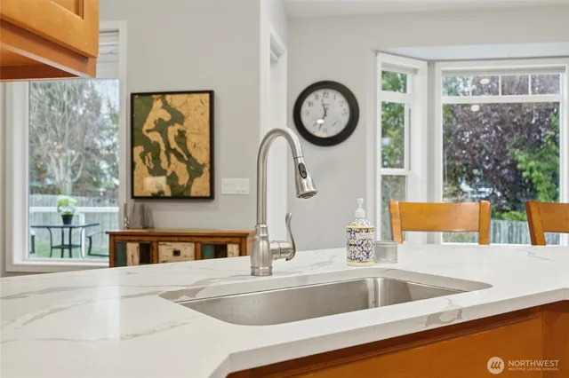 a kitchen with a large window and a sink