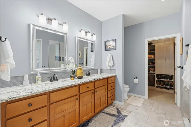 a spacious bathroom with double sink and a mirror