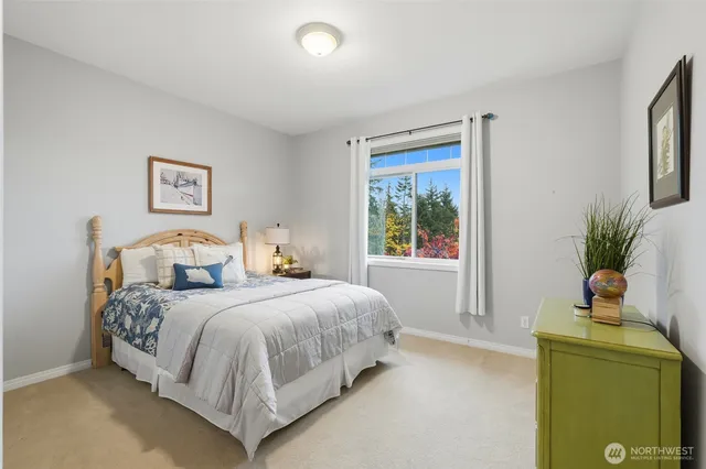 a bedroom with a bed and a potted plant