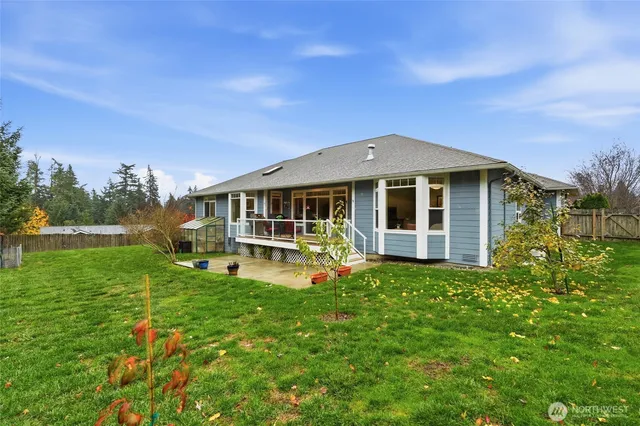 a front view of a house with a yard table and chairs