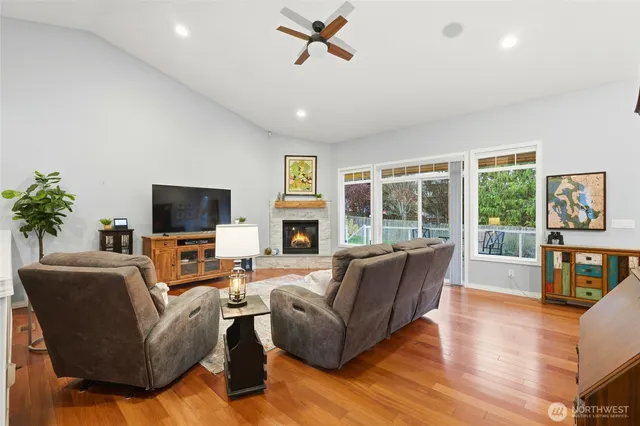 a living room with furniture flat screen tv and a large window
