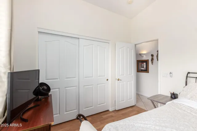 a bedroom with a bed and a closet