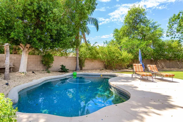 a view of a backyard with swimming pool