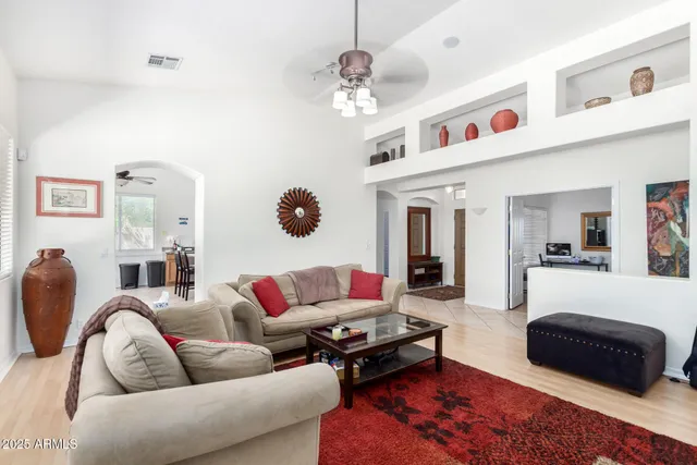 a living room with furniture ceiling fan and a rug