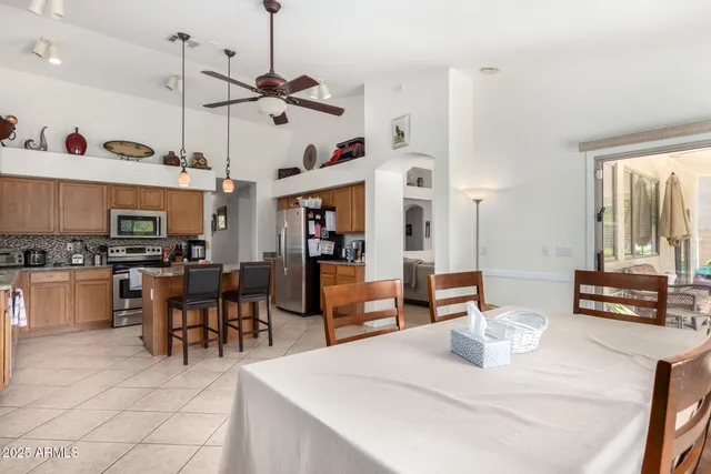 a kitchen with stainless steel appliances kitchen island granite countertop a sink and cabinets
