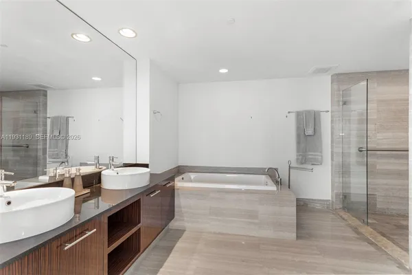 a bathroom with a bathtub and shower