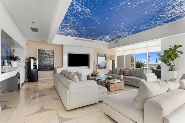 a kitchen with stainless steel appliances granite countertop a stove top oven a dining table and chairs with wooden floor