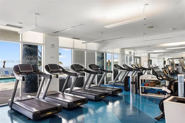 a view of a room with lots of gym equipment