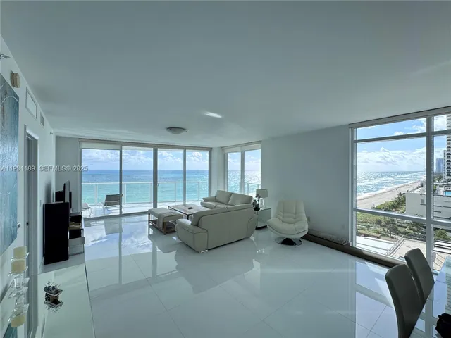 a living room with furniture and large windows