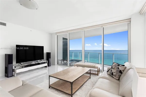 a living room with furniture and a large window