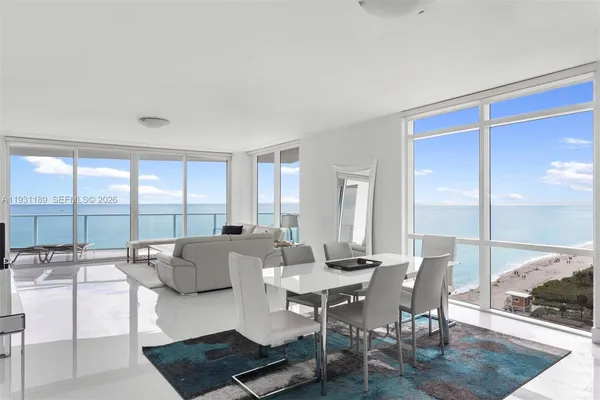 a bedroom with a bed and a flat tv screen next to a large window