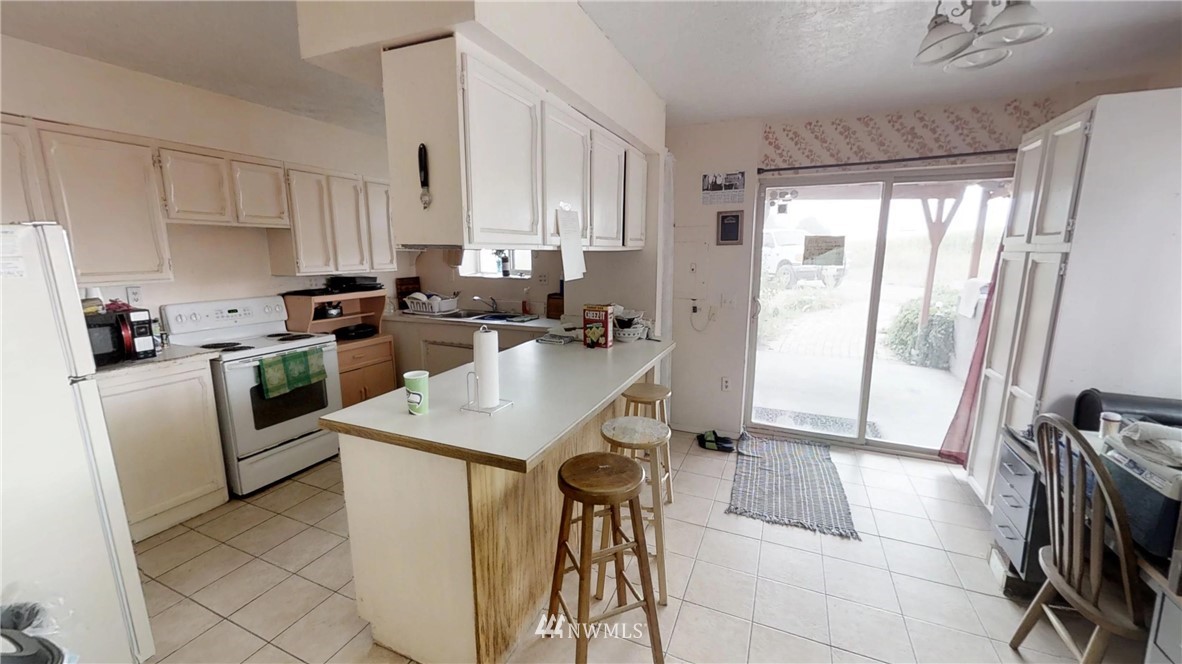 3956 L L.2 Road Northeast Moses Lake, WA 98837 - Photo 13 of 14 a kitchen with stainless steel appliances granite countertop a sink a stove and a refrigerator