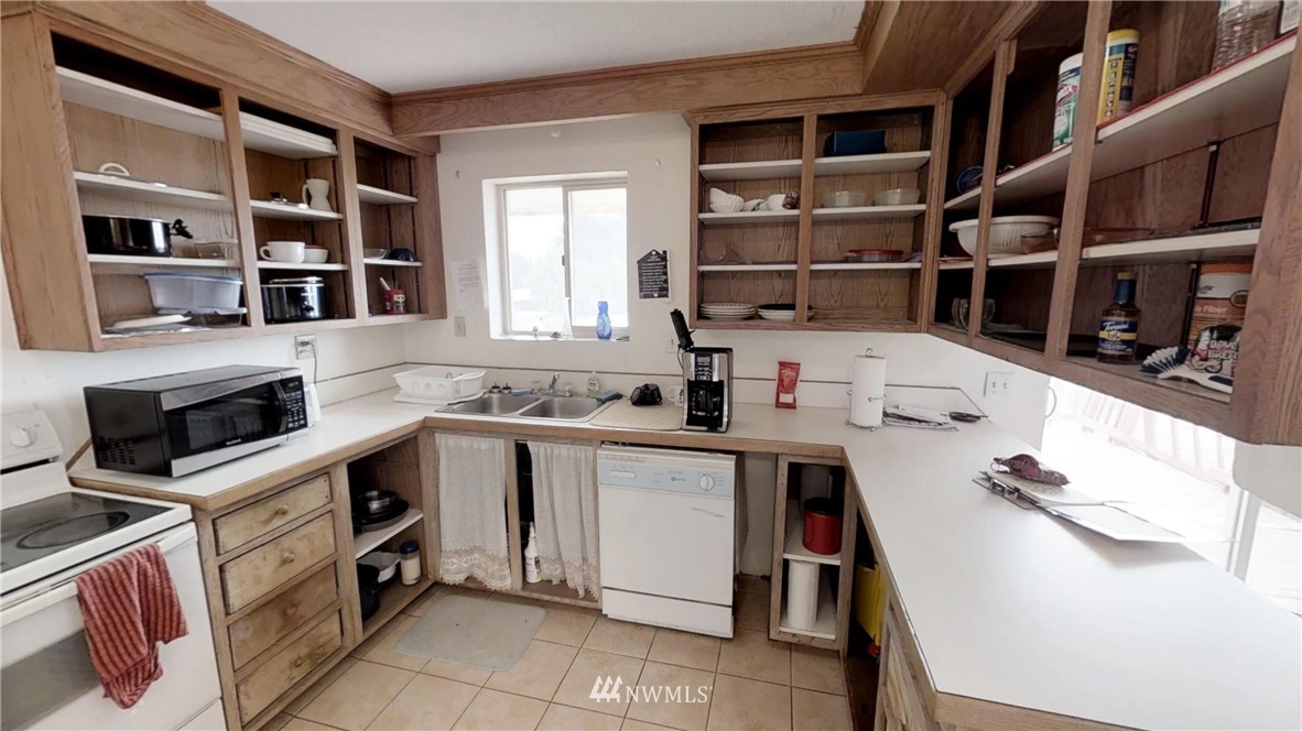 3956 L L.2 Road Northeast Moses Lake, WA 98837 - Photo 7 of 14 a kitchen with a sink a stove and cabinets