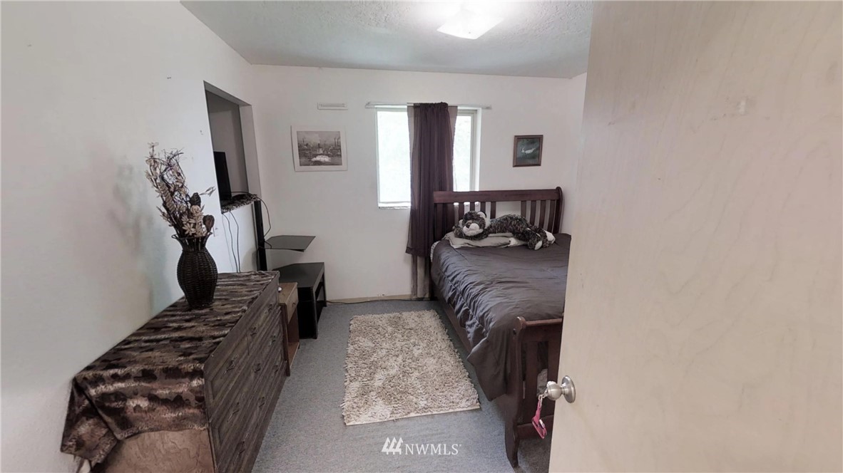 3956 L L.2 Road Northeast Moses Lake, WA 98837 - Photo 10 of 14 a bed room with furniture and a chandelier