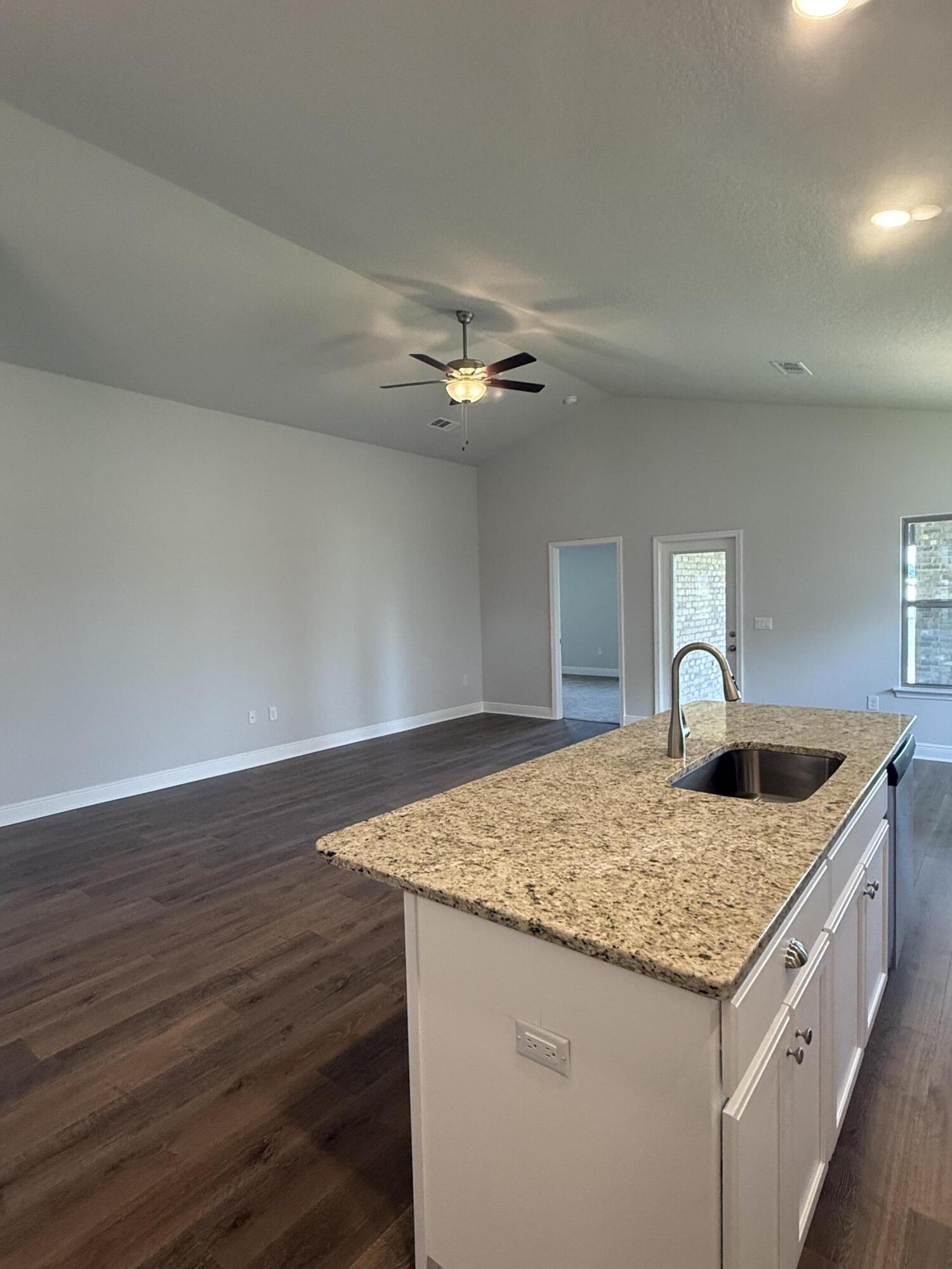 190 Ridgeway Circle Crestview, FL 32536 - Photo 14 of 19 a kitchen with a granite countertop sink and white cabinets