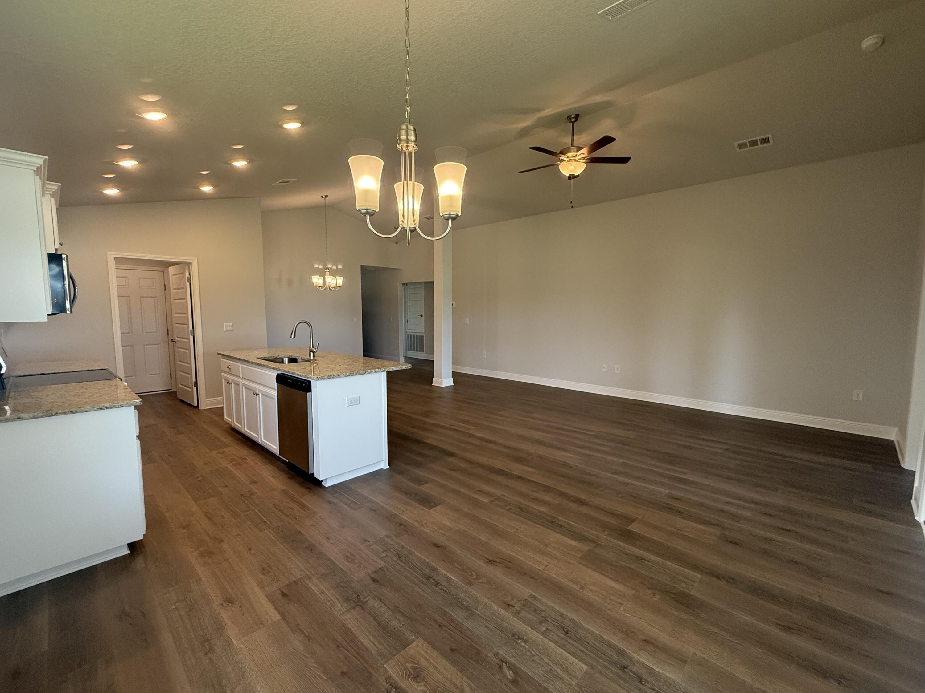 190 Ridgeway Circle Crestview, FL 32536 - Photo 15 of 19 a view of a kitchen with sink microwave and wooden floor
