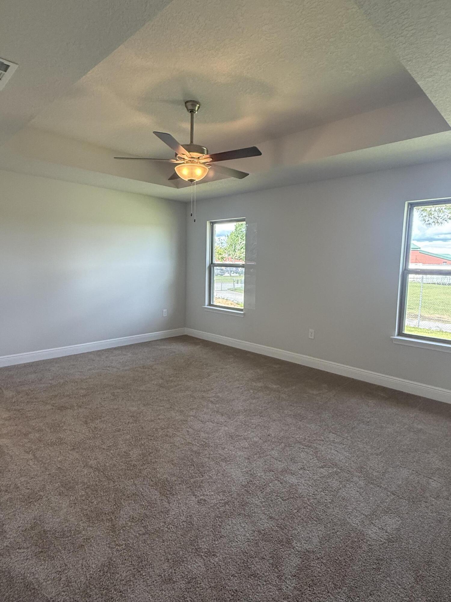190 Ridgeway Circle Crestview, FL 32536 - Photo 16 of 19 en empty room with windows and ceiling fan